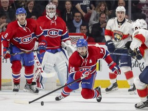 Montreal Canadiens' Shea Weber and goalie Carey Price and, Florida Panthers' Reilly Smith, 18, watch as Habs' Tomas Plekanec pokes the puck away from Panthers Jason Demers, right, during third period of National Hockey League game in Montreal Tuesday November 15, 2016.