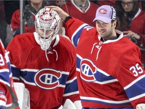 Canadiens backup goalie Al Montoya (right) gives Carey Price a pat on the head after Price shut out the Vancouver Canucks in Montreal on Wednesday, Nov. 2, 2016.