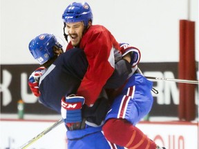 Andrew Shaw leaps into Zach Redmond's arms during Montreal Canadiens practice at the Bell Sports Complex in Brossard on Monday November 21, 2016(