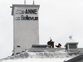 An employee takes pictures of the hose tower on top of Ste-Anne-de-Bellevue' town hall Nov.r 22, 2016. A Canadian veteran wants to help pay for its restoration.