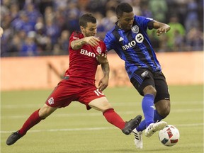 Montreal Impact's Patrice Bernier and Toronto FC's Sebastian Giovinco fight for control of the ball during first half action in game 1 of the MLS Eastern Conference final held at Olympic stadium in Montreal on Tuesday November 22, 2016.