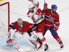 Montreal Canadiens goalie Carey Price keeps an eye on the play while Carolina Hurricanes' Viktor Stalberg (25) sneak's in between Price an Greg Pateryn (8), during second period NHL action in Montreal on Thursday November 24, 2016.