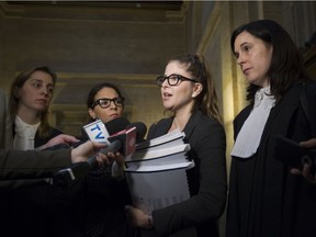 SPCA lawyer and campaigns manager Sophie Gaillard, centre, speaks to reporters at the Montreal Court of Appeal on Notre Dame St. in Old Montreal, Friday Nov. 25, 2016, after the city challenged, in court, the indefinite suspension of parts of its animal control bylaw that targeted "pit bull-type dogs." Listening are lawyer Sibel Ataogul, left, SPCA director Alanna Devine and Marie-Claude St-Amand, right.
