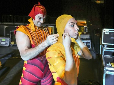 Acrobat Anatoli Boiko helps partner Inna Bekmamadova with her costume backstage at rehearsal of Cirque du Soleil's Ovo at the Bell Centre in Montreal Tuesday November 29, 2016.
