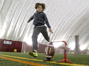 Jayden Rice, 11, kicks a football during practice at the Concordia University Soccer Dome on Sherbrooke Street in NDG, Montreal, Tueday November 29, 2016.  He'll be participating in an NFL sanctioned punt, pass and kick competition on December 4, in Foxborough, Massachusetts, during halftime of New England Patriots' game.