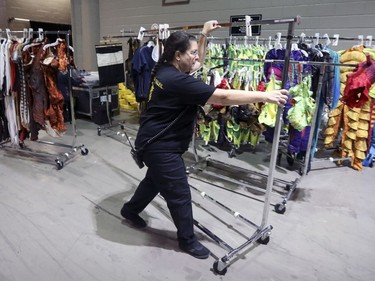 Wardrobe assistant Amy Brown wheels a clothes rack backstage at rehearsal of Cirque du Soleil's Ovo at the Bell Centre in Montreal Tuesday November 29, 2016.