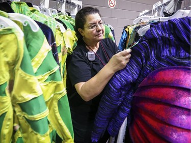 Wardrobe assistant Amy Brown checks on costumes drying on racks backstage at rehearsal of Cirque du Soleil's Ovo at the Bell Centre in Montreal Tuesday November 29, 2016.
