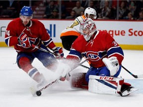 Canadiens goalie Carey Price pulls in a loose puck as Montreal Canadiens defenceman Alexei Emelin covers him against the Philadelphia Flyers at the Bell Centre in Montreal on Saturday, Nov. 5, 2016.