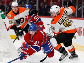 Canadiens' Paul Byron is knocked to the ice by Philadelphia Flyers defenceman Shayne Gostisbehere during NHL action at the Bell Centre in Montreal on Saturday, Nov. 5, 2016.