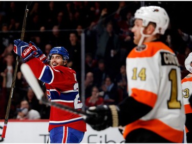 Canadiens left wing Phillip Danault celebrates as he looks back at Philadelphia Flyers centre Sean Couturier after scoring against Philadelphia Flyers goalie Michal Neuvirth during NHL action at the Bell Centre in Montreal on Saturday, Nov, 5, 2016.