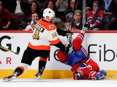 Canadiens' Alexander Radulov gets turned upside down by Philadelphia Flyers centre Sean Couturier during NHL action at the Bell Centre in Montreal on Saturday, Nov. 5, 2016.