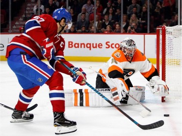 Philadelphia Flyers goalie Michal Neuvirth beats Montreal Canadiens' Max Pacioretty to the puck during NHL action at the Bell Centre in Montreal on Saturday, Nov. 5, 2016.