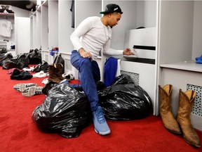 Alouettes quarterback Vernon Adams Jr. empties his locker as the team clears out the room in Montreal on Sunday, Nov. 6, 2016.