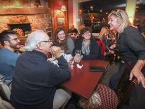 Waitress Tracy Asbil chats with customers  Kim Haze Vuong (from left), Alan Cowling, Brittnie Asselin-Cowling and Celine Asselin in the pub on the last night of business at The Willow in Hudson on Monday, October 31, 2016. (John Mahoney / MONTREAL GAZETTE)
