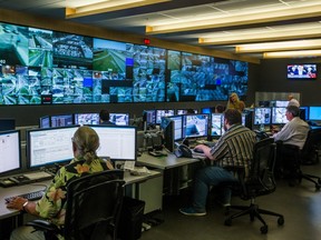 Workers look at live video feeds at Transport Quebec's upgraded traffic control centre for the area of Montreal on Sept. 1, 2015.