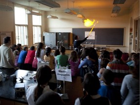 Prospective students and their parents watch a science demonstration at a Montreal high school open house in 2011.