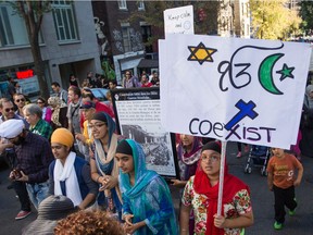 People take part in a protest against the proposed Charter of Quebec Values by the Parti Quebecois government in Montreal on Sunday, September 29, 2013.