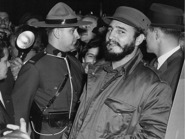 Cuban leader Fidel Castro is guarded by a member of the RCMP in April 1959 as he is surrounded by a crowd on arrival at the Queen Elizabeth Hotel.