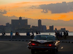 People spend the afternoon sitting on the Havana sea wall in Cuba, Nov. 9, 2016. Cuban President Raul Castro congratulated United States President-Elect Donald Trump in what appeared to have been a terse message to the man who could roll back two years of detente.