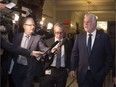 Quebec Premier Philippe Couillard walks past reporters after a caucus meeting at the provincial legislature, in Quebec City on Wednesday, November 2, 2016. To its credit, the Couillard government, which first had announced more limited measures, was quick to see the need for a broader inquiry into revelations about police spying on journalists.