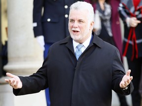 Quebec Premier Philippe Couillard gestures to the press after his meeting with French President Francois Hollande at the Elysee Palace in Paris, Wednesday, Nov. 23, 2016.