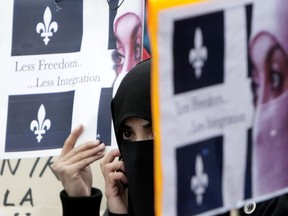 A woman demonstrates in 2010 against Bill 94, which never became law. Its provisions on face coverings were similar to those of the current Bill 62. The Quebec Human Rights Commission says it fears banning face coverings might add to the “stigmatization and marginalization” of those women, and would restrict their ability to “act freely, exercise their rights and interact within society.”