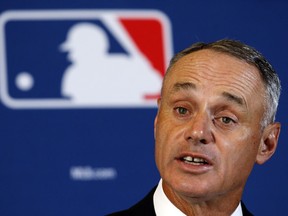 In this Feb. 22, 2016, file photo, Major League Baseball Commissioner Rob Manfred answers a question during a news conference in Phoenix.