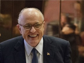 Former New York Mayor Rudy Giuliani, smiles as he leaves Trump Tower, Friday, Nov. 11, 2016, in New York.