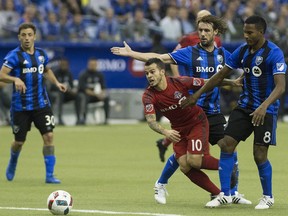 Montreal Impact's Marco Donadel, centre, and Patrice Bernier, right, challenge Toronto FC's Sebastian Giovinco (10) during first half soccer action of the first leg of the MLS Eastern Conference final at the Olympic Stadium in Montreal, Tuesday, November 22, 2016.