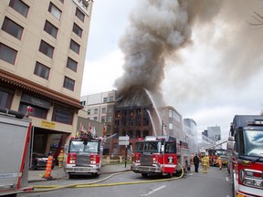 Firefighters battle a blaze in Montreal's Chinatown Thursday at the corner of St-Laurent Blvd. and Viger Ave.