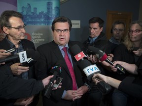 Montreal Mayor Denis Coderre, centre, speaks to the media on Sunday, Nov. 6, 2016. Coderre insists he was only acting as an ordinary citizen when he picked up the phone in 2014 and called then-police chief Marc Parent to complain about information leaked to La Presse columnist Patrick Lagacé.