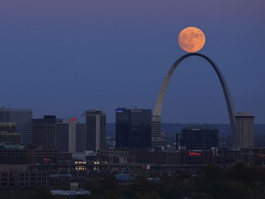 The moon rises beyond the Arch in St. Louis as seen from the Compton Hill Water Tower Nov. 13, 2016. Monday morning's supermoon will be the closet a full moon has been to the Earth since Jan. 26, 1948.