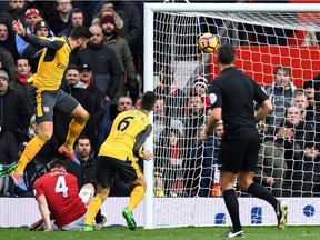 Arsenal's French striker Olivier Giroud, left, scores his team's first goal during the English Premier League football match between Manchester United and Arsenal at Old Trafford in Manchester, north west England, on Nov. 19, 2016.