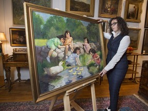 A.H. Wilkens Auctions and Appraisals COO & Senior Appraiser Andrea Zeifman stands with a Gil Elvgren painting of The Dionne Quintuplets, Monday November 28, 2016. The Elvgren painting was made in 1937 for a 1939 Dionne Quintuplets calendar.