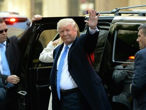 Republician presidential nominee Donald Trump waves as he arrives at a polling station in New York where he was to cast his ballot, Nov. 8, 2016.