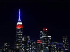 The Empire State Building in New york is lit in red, white and blue on Nov. 8, 2016 as seen from Weehawken, New Jersey, before the closing of polls in the US presidential election.