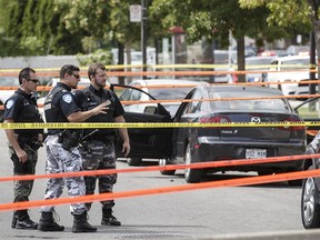 Montreal police survey the scene in Ahuntsic-Cartierville where Joseph Sarikakis, 45, was shot dead while he was behind the wheel of his car. Of the 23 reported homicides this year, seven appear to have clear ties to organized crime or drug trafficking, and arrests were made in at least 15 cases.