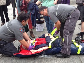 A protester is helped by paramedics after a scuffle with police following Denis Coderre's news conference in Montreal on Thursday May 16, 2013.