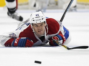 Montreal Canadiens center Andrew Shaw dives for the puck during the second period of an NHL hockey game against the Los Angeles Kings, Sunday, Dec. 4, 2016, in Los Angeles.