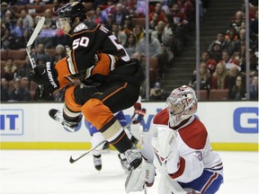 Anaheim Ducks' Antoine Vermette, left, jumps out of the way of the puck in front of Montreal Canadiens goalie Carey Price during the second period of an NHL hockey game Tuesday, Nov. 29, 2016, in Anaheim, Calif.