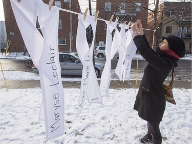 Caroline Jacquest hangs ribbons to commemorate the 14 victims of the Ecole Polytechnique shooting before a memorial ceremony to mark the 27th anniversary of the Montreal Massacre on Tuesday, December 6, 2016 in Montreal.