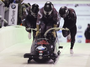 Driver Chris Spring with Cameron Stones, Lascelles Brown and brakeman Samuel Giguère of Canada compete in the four-man bobsled on the way to a third-place finish in the World Cup race Saturday, Dec. 17, 2016, in Lake Placid, N.Y.