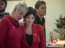 Manon Boyer, centre, aunt of Éloïse Dupuis, and Marie-Chantal Dubé, left, a friend of Éloïse, and Boyer's friend Robert Beauchemin, right, become emotional as they listen to a song during a memorial event for Dupuis in Laval on Saturday, Dec. 3, 2016. 