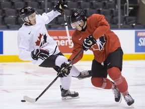 Canada's Dylan Strome, right, takes the puck past Jake Bean during a practice session ahead of the IIHF World Junior Championship in Toronto on Saturday, Dec. 24, 2016.