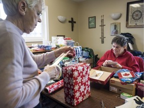 Emma Garnett, left, and Sylvia MacAskill pack and wrap donated gifts for mariners at the Missions to Seafarers, in Halifax on Wednesday, Dec. 21, 2016.