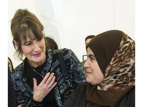 Quebec Immigration minister Kathleen Weil, left, talks with Syrian refugee Faten Nseirat during an event to mark the one year anniversary of the arrival of refugees from Syria to Canada in 2016.