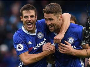 Chelsea's Spanish defender Cesar Azpilicueta, left, and Chelsea's English defender Gary Cahill celebrate following the English Premier League football match between Manchester City and Chelsea at the Etihad Stadium in Manchester, north west England, on Dec.3, 2016. Chelsea won the match 3-1.