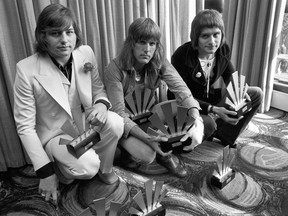 This is a Sept. 30, 1972 file photo of the members of the rock band Emerson, Lake and Palmer, Greg Lake, left Keith Emerson, centre, and Carl Palmer after an award ceremony in London. Greg Lake, the prog-rock pioneer who co-founded King Crimson and Emerson, Lake and Palmer, has died. He was 69. Lake died Wednesday Dec, 7, 2016 after "a long and stubborn battle with cancer," according to his manager.