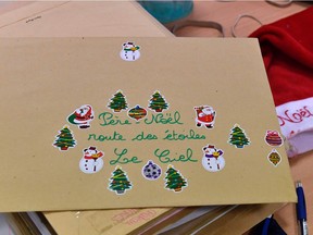 A letter to Santa Claus lies on a table at a 'secretary of Santa Claus' where people are answering letters addressed to Santa Claus at a mail sorting office in Libourne, southwestern France, on December 20, 2016. Over 1 million letters are addressed to Santa Claus every Christmas.