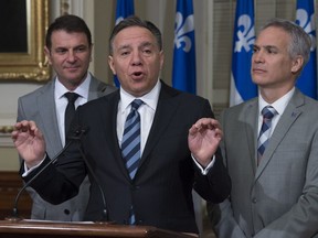 Coalition Avenir Québec Leader François Legault (centre) says the answer to American protectionism is not more protectionism.